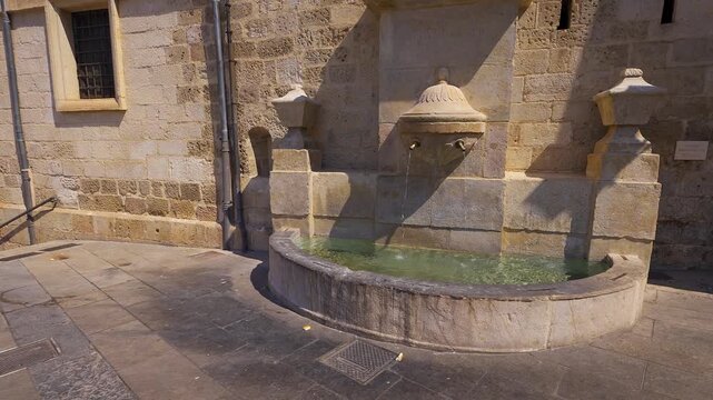 Stone fountain in Plaza Mayor surrounded by historic architecture in Cuenca Castilla La Mancha