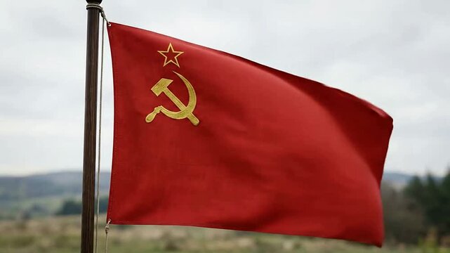 Red flag with Soviet hammer and sickle symbol waving in the wind