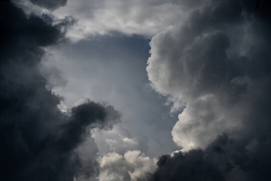 Massive ominous thunderhead formations developing in a moody sky illustrating meteorological forecasting and climate study for environmental research projects