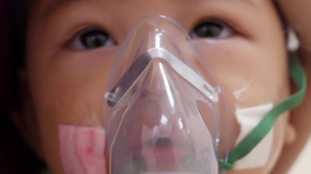 Sick Baby Boy Wearing Nebulizer Mask During Breathing Therapy in Hospital