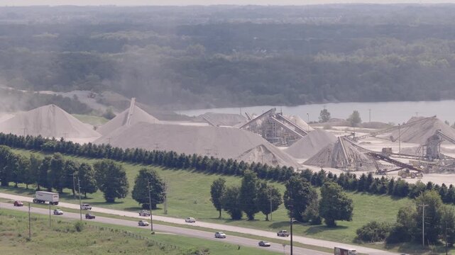 Drone aerial of huge mineral plant and mine along interstate 71 i71 road and highway, as industrial mining of gravel, limestone, sand, and other minerals are mined from Ohio equipment by Columbus, OH