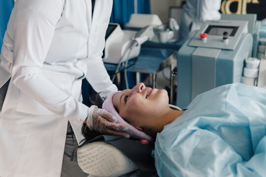 Young woman at the dermatologist.
