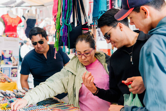 Group of tourists buying souvenirs.