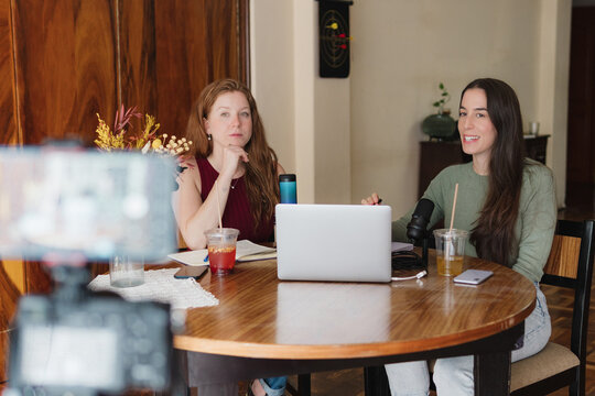 Friends at home recording a podcast.