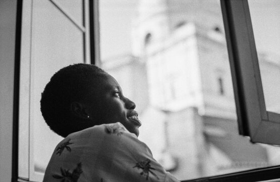 Smiling by Open Window