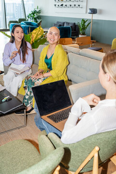 Women Chatting in a Modern Office Space During a Work Meeting