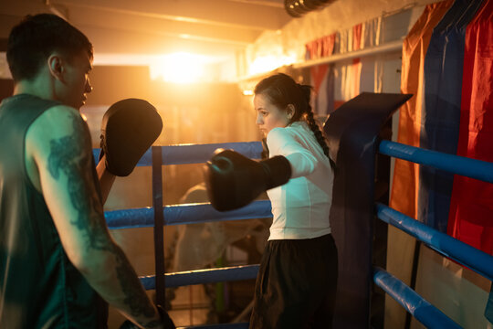 Female Boxer  and coach training in the boxing ring. Woman Power