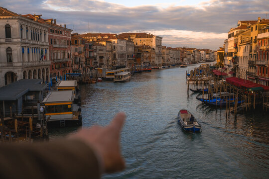 Pointing at Grand Canal Sunrise from Rialto Bridge in Venice