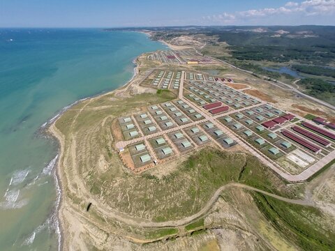 Aerial view of Animal Shelter Of Kisirkaya with rows of enclosures and buildings situated on a grassy cliff overlooking the Black Sea coast in Sariyer, Istanbul, Turkey.