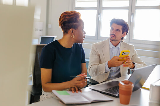 Business professionals discussing in modern office