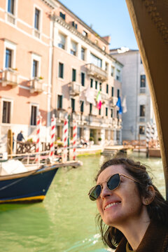 Smiling tourist on a boat in Venice