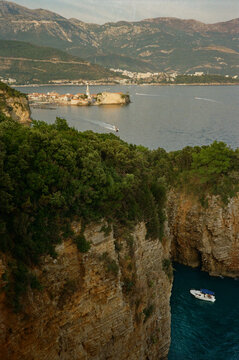 Coastline View With a Boat Near a Rocky Cliff. Bidva, Montenegro.