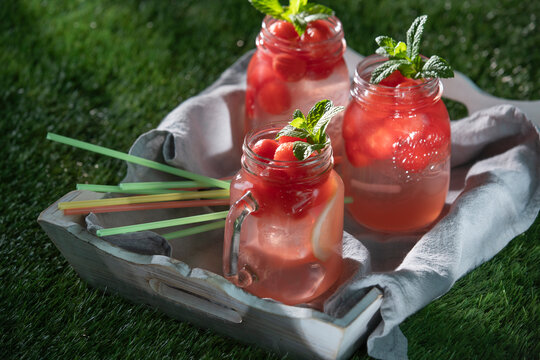 Watermelon lemonade drinks with mint on grass tray