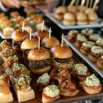 Mini burgers and appetizers laid out for catering
