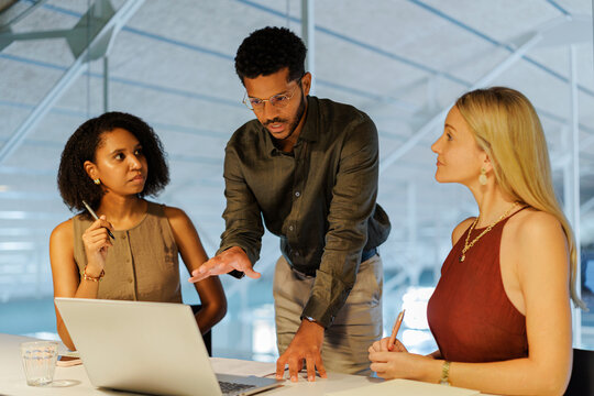 Professionals collaborating during business meeting at office