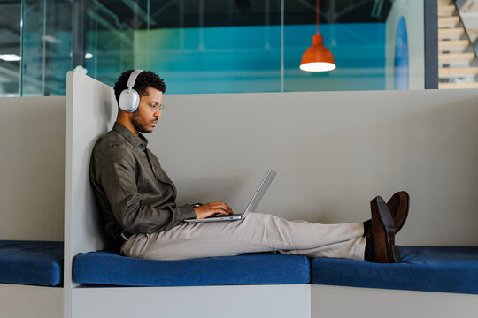 Man working remotely in modern office with laptop