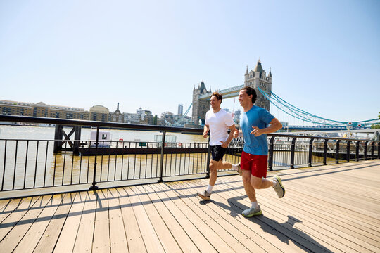 Two Men Jogging by the River Thames
