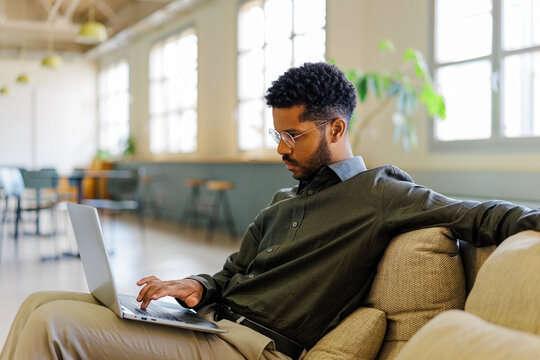 Remote worker typing on laptop in modern office