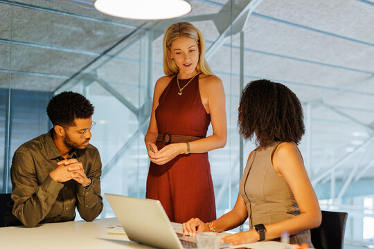 Business colleagues collaborating on project in modern office