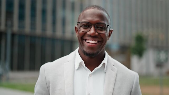 Executive director, african american businessman, confident portrait, outdoor near office building. Black business man smiling, works as executive director, managing key business accounts. Copy space