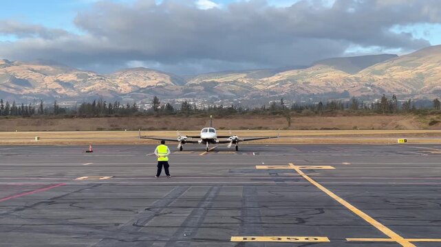 Small Twin Engine Airplane Preparing for Takeoff on Mountain Airport Runway