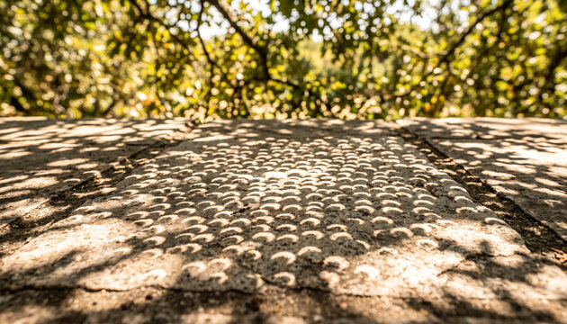 Projection of solar eclipse on a surface created by a tree leaf during a partial solar eclipse event