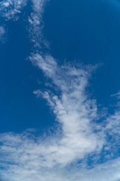 White cloud formation against deep blue sky with copy space
