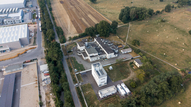 Aerial view of Rai Way Edge Data Center and telecommunications infrastructure surrounded by agricultural fields and industrial buildings in Siziano, Lombardy, Italy.