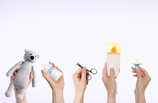 Women holding toy bear, feeding bottle and other baby stuff on light background, set