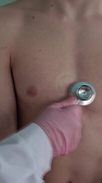 Examining a patient with a stethoscope in a clinic setting