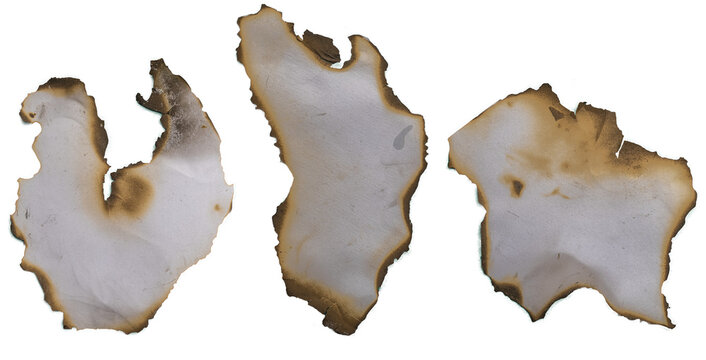 burnt holes in piece of paper isolated on white background.