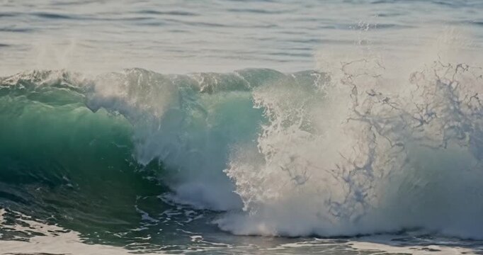 Breaking turquoise ocean wave close up
