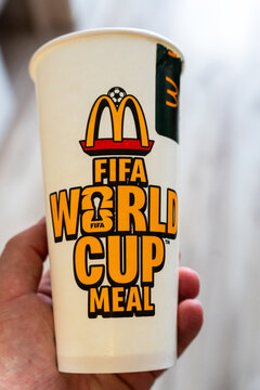 Warsaw, Poland - July 30, 2026: McDonald's FIFA World Cup Meal paper cup held in hand, featuring official FIFA World Cup branding and golden arches logo
