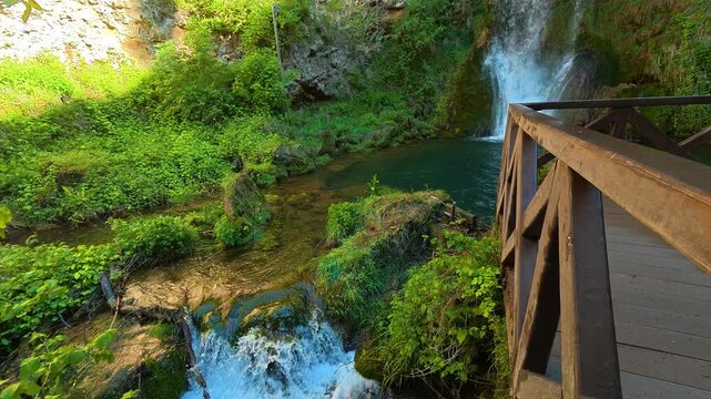 Lush greenery surrounds cascading waterfall. Veliki Buk, Serbia.