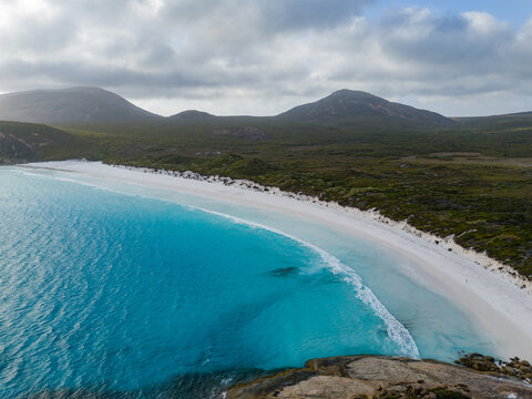 Aerial view of Hellfire Bay with its turquoise waters, white sand beach, and surrounding coastal hills in Cape Le Grand National Park, Western Australia, Australia.