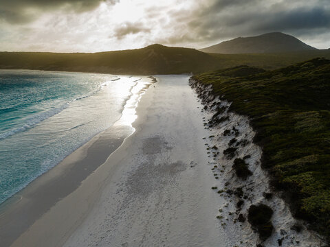 Aerial view of Hellfire Bay with white sand, turquoise waves, and coastal vegetation in Cape Le Grand National Park, Western Australia, Australia.