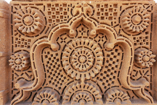 View of the intricate sandstone carvings featuring geometric patterns and floral motifs on the historic Chaukhandi Tombs in Karachi, Sindh, Pakistan.