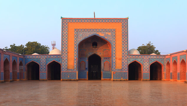 View of the intricate blue tile work and arched doorways of the historic Shah Jahan Masjid in Thatta, Sindh, Pakistan.
