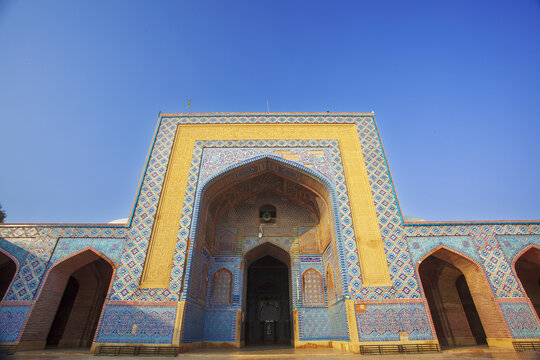 View of the intricate blue tile work and arched entrance of Shah Jahan Masjid Thatta in Thatta, Sindh, Pakistan.
