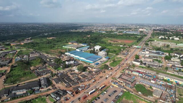 Aerial view of IDL factory in Ota, surrounded by industrial buildings, residential areas, and green vegetation in Ota, Ogun State, Nigeria.