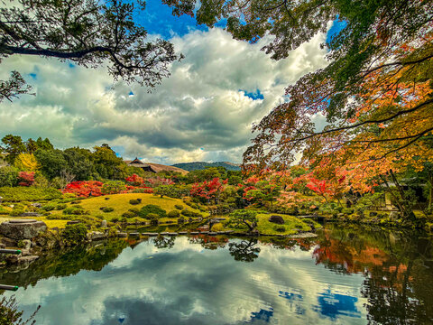 View of the tranquil pond and vibrant autumn foliage at Isuien Garden and Neiraku Museum in Nara, Nara, Japan.