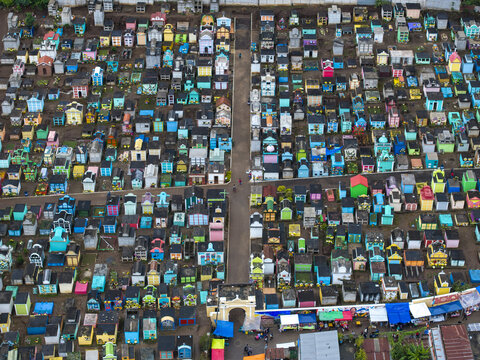 Aerial view of the colorful General Cemetery with rows of brightly painted mausoleums and tombs arranged in a grid pattern in Guatemala.