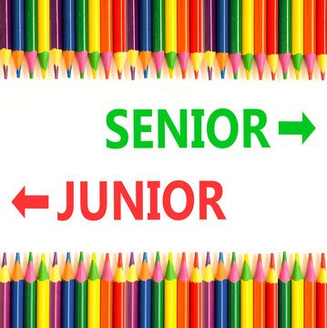 Senior or junior words symbol. Concept words Senior Junior on beautiful white paper. Beautiful white background. Colored pencils. Business and senior or junior concept. Copy space.