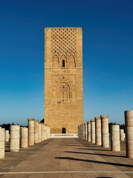 View of the historic Hassan Tower with its intricate stone carvings and surrounding rows of marble columns under a clear blue sky in Rabat, Rabat-Sale-Kenitra, Morocco.