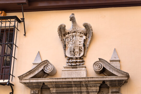 A stone sculpture of the royal coat of arms of Spain
