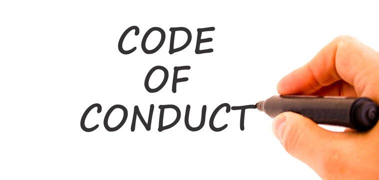 Code of conduct words symbol. Concept words Code of conduct on beautiful white paper. Beautiful white background. Businessman hand with pen. Business Code of conduct concept. Copy space.