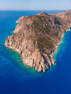 Aerial view of the rocky coastline of Kos with turquoise waters and rugged cliffs in Kos, Greece.