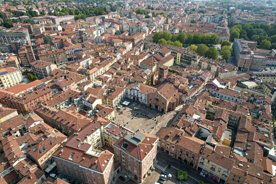 Aerial view of the historic center of Asti with its dense terracotta rooftops, narrow streets, and the prominent Cathedral of Santa Maria Assunta and San Gottardo in Asti, Piedmont, Italy.