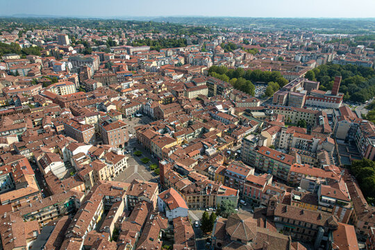 Aerial view of the historic city center of Asti featuring dense terracotta rooftops, narrow streets, and traditional architecture in Asti, Piedmont, Italy.