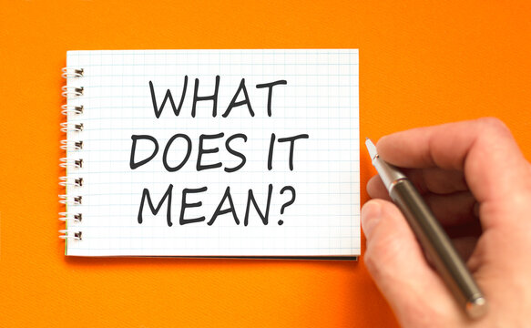 What does it mean symbol. Concept words What does it mean on beautiful white note. Beautiful orange background. Businessman hand. Business What does it mean motivational support concept. Copy space.